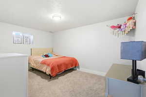 Bedroom with carpet floors and a textured ceiling