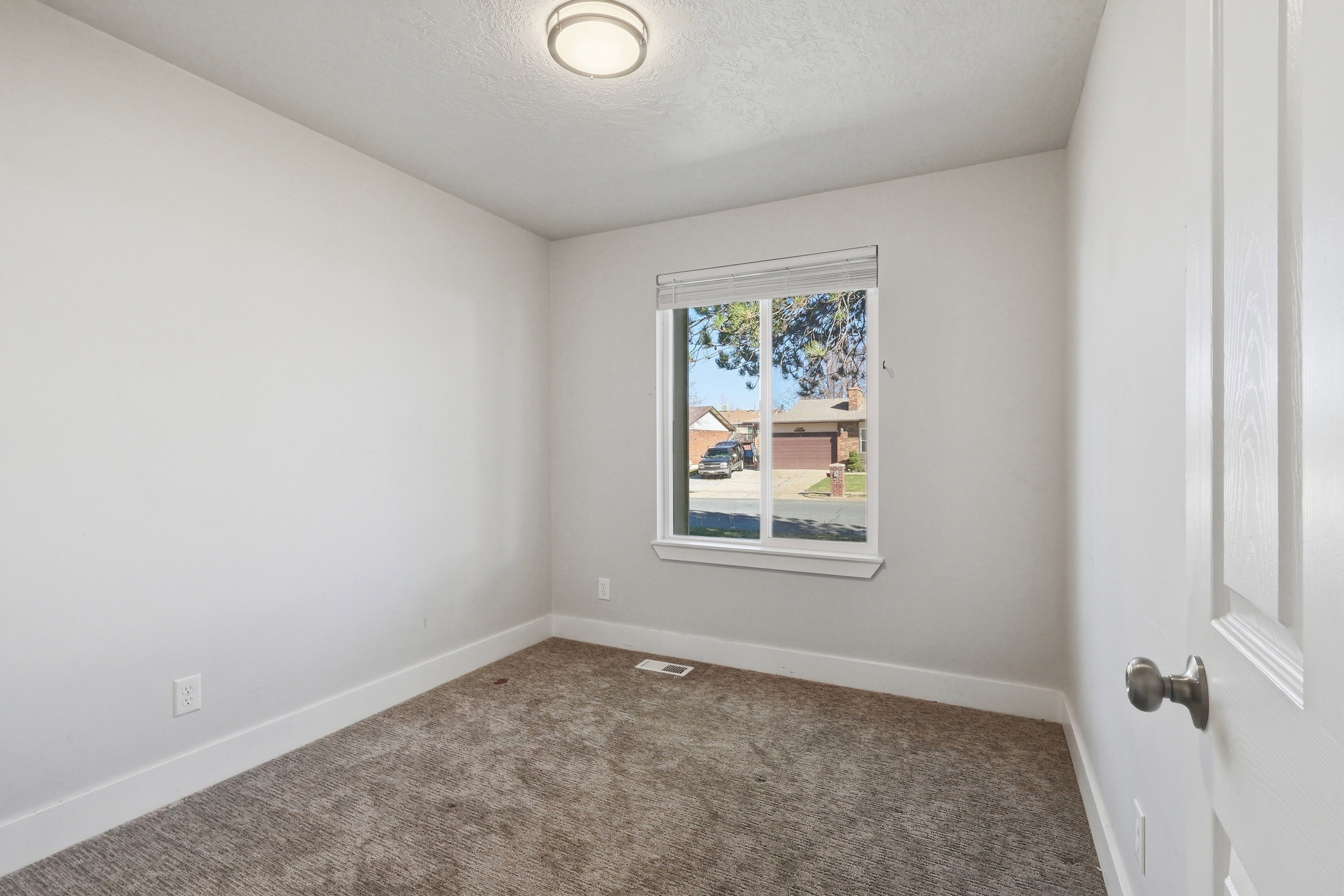 Spare room with dark carpet and a textured ceiling