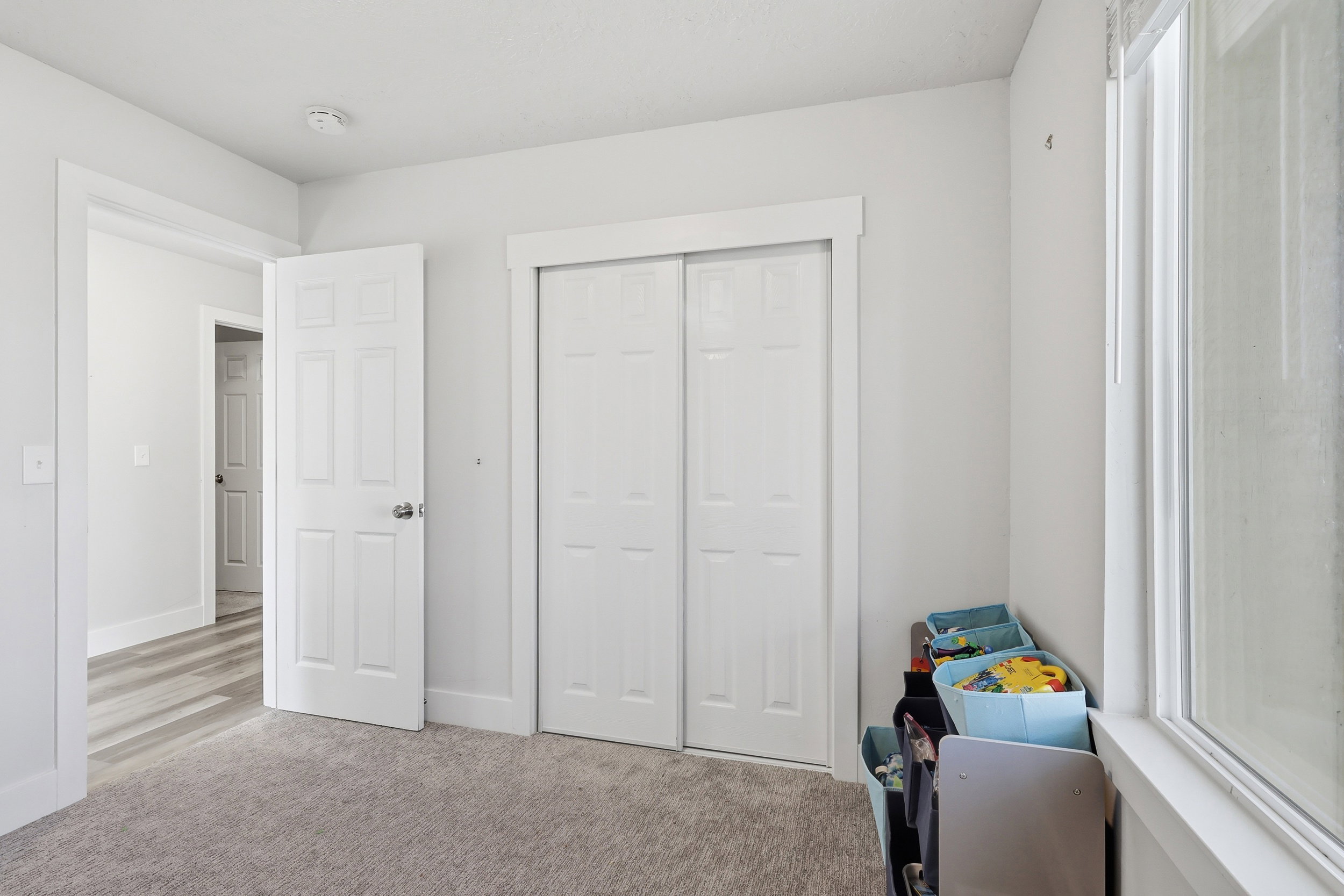 Bedroom featuring light colored carpet and a closet