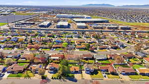 Aerial view of property's location featuring nearby suburban area and a mountainous background