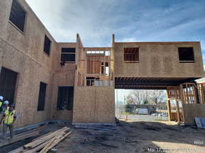 View of front of property featuring a balcony and stucco siding