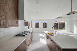 Kitchen with light stone countertops, modern cabinets, and a large island