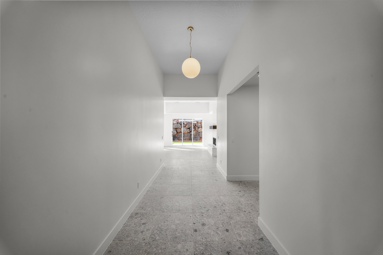 Hallway with baseboards and a high ceiling
