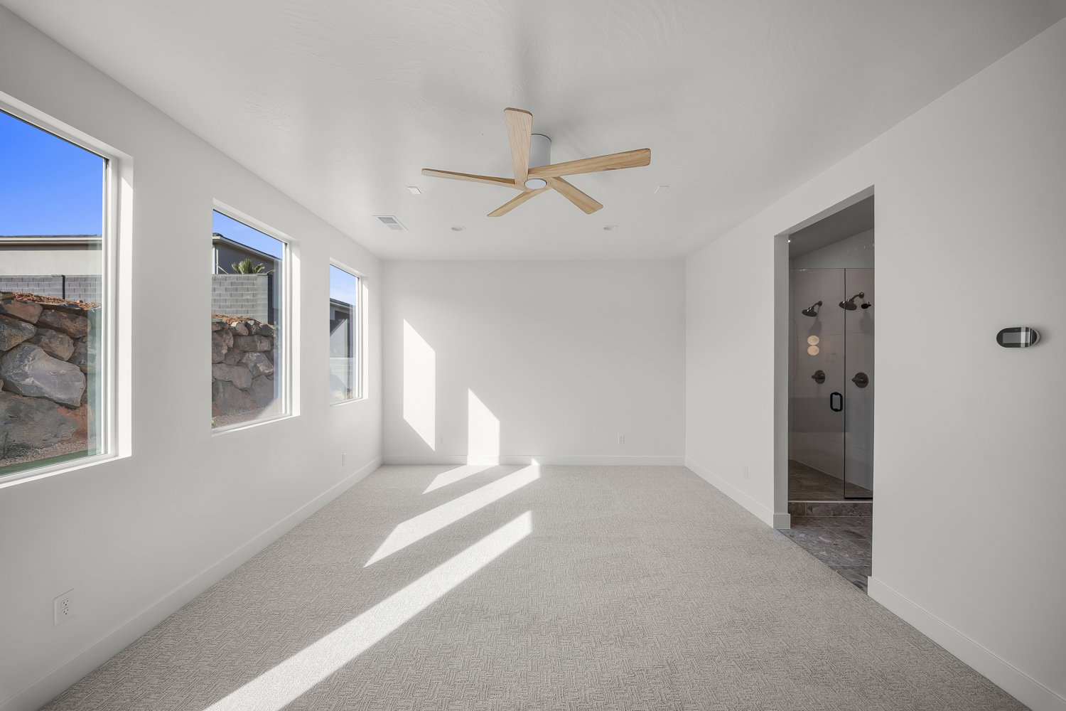 Spare room with light colored carpet and a ceiling fan