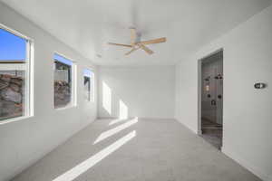 Spare room with light colored carpet and a ceiling fan
