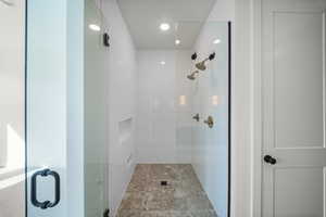 Bathroom with a shower stall and recessed lighting