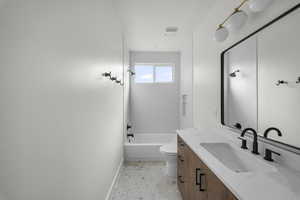 Bathroom featuring vanity and shower / bath combination