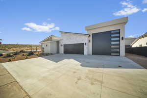 Contemporary home featuring driveway, a garage, and stucco siding