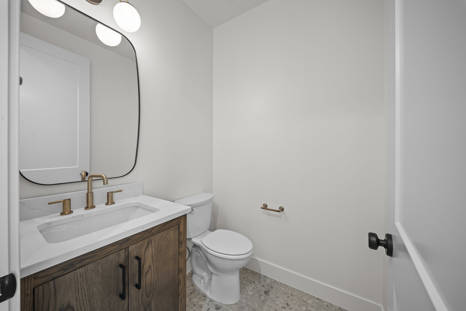 Half bathroom featuring vanity and baseboards