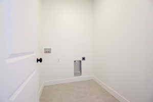 Laundry room with electric dryer hookup, washer hookup, and light tile patterned floors