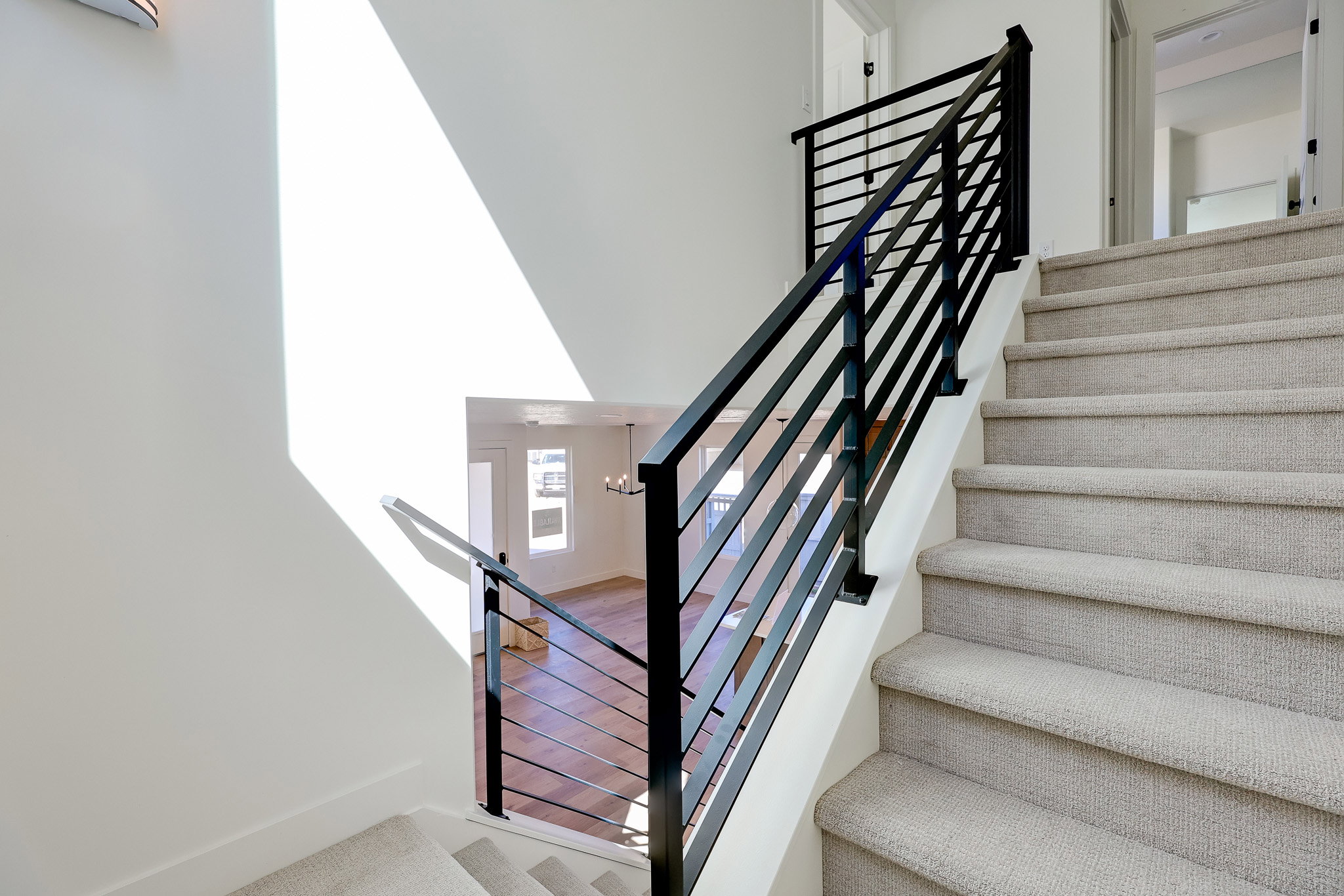 Stairs featuring metal railing and a high ceiling
