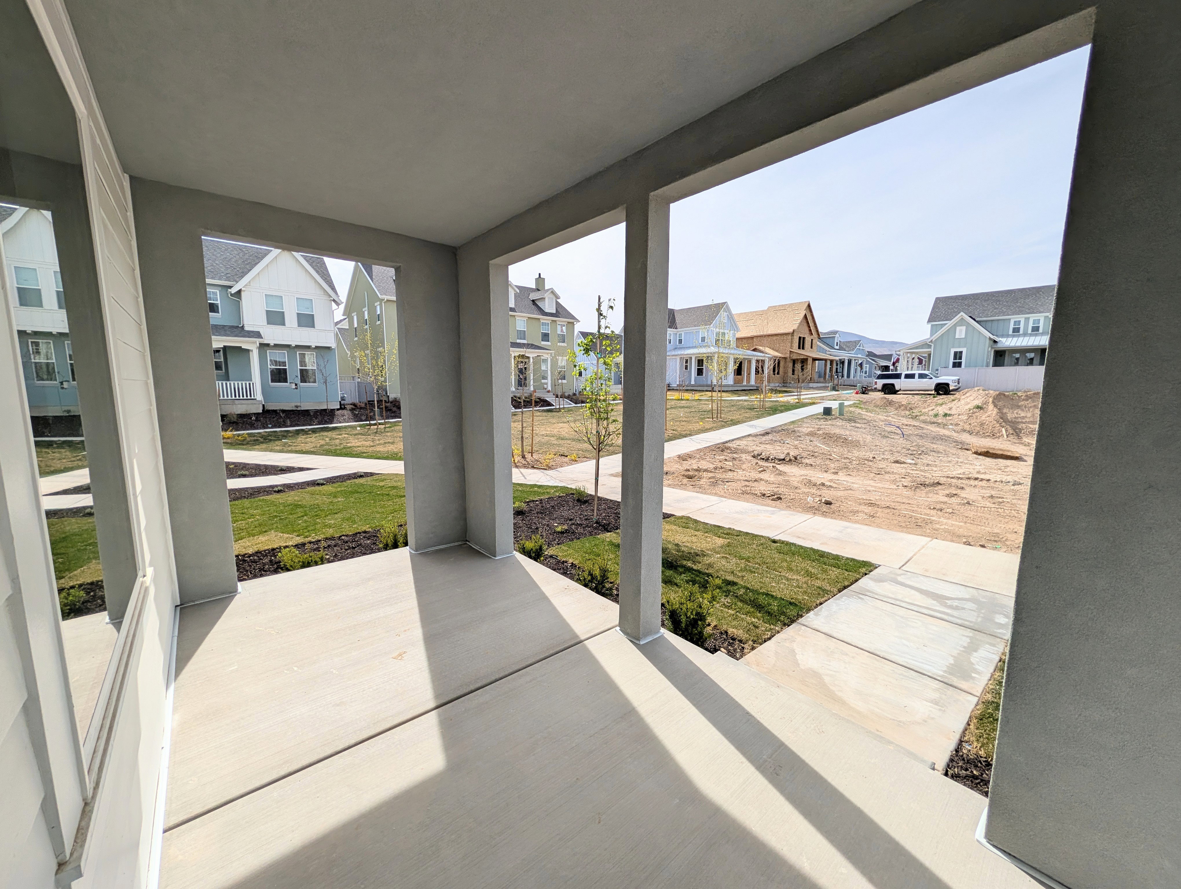 Covered porch featuring a residential view