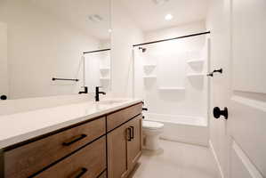 Basement Bathroom featuring vanity, shower / bath combination with curtain, light tile patterned flooring, and recessed lighting