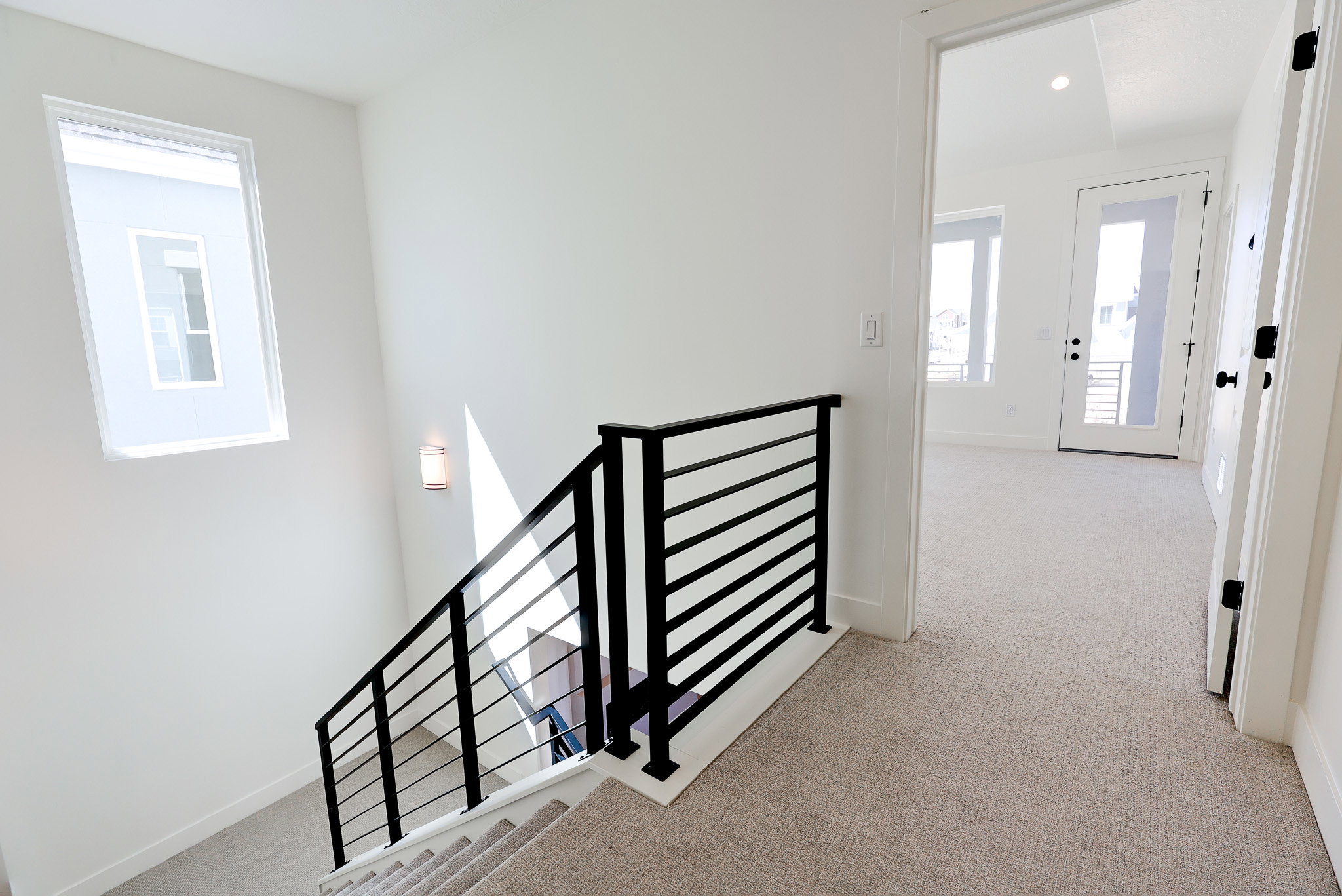 Stairs featuring metal railing and a high ceiling