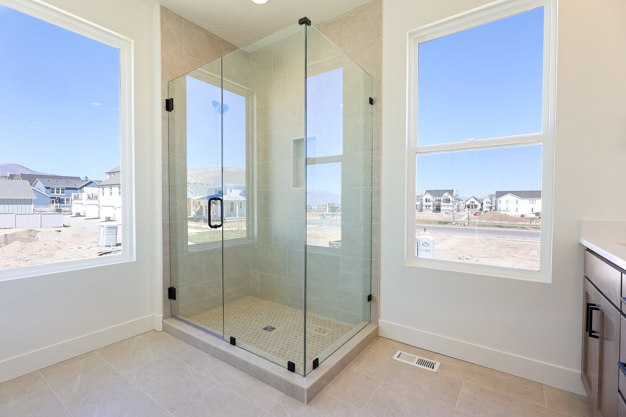 Primary Bathroom featuring vanity, a stall shower, plenty of natural light, and a residential view