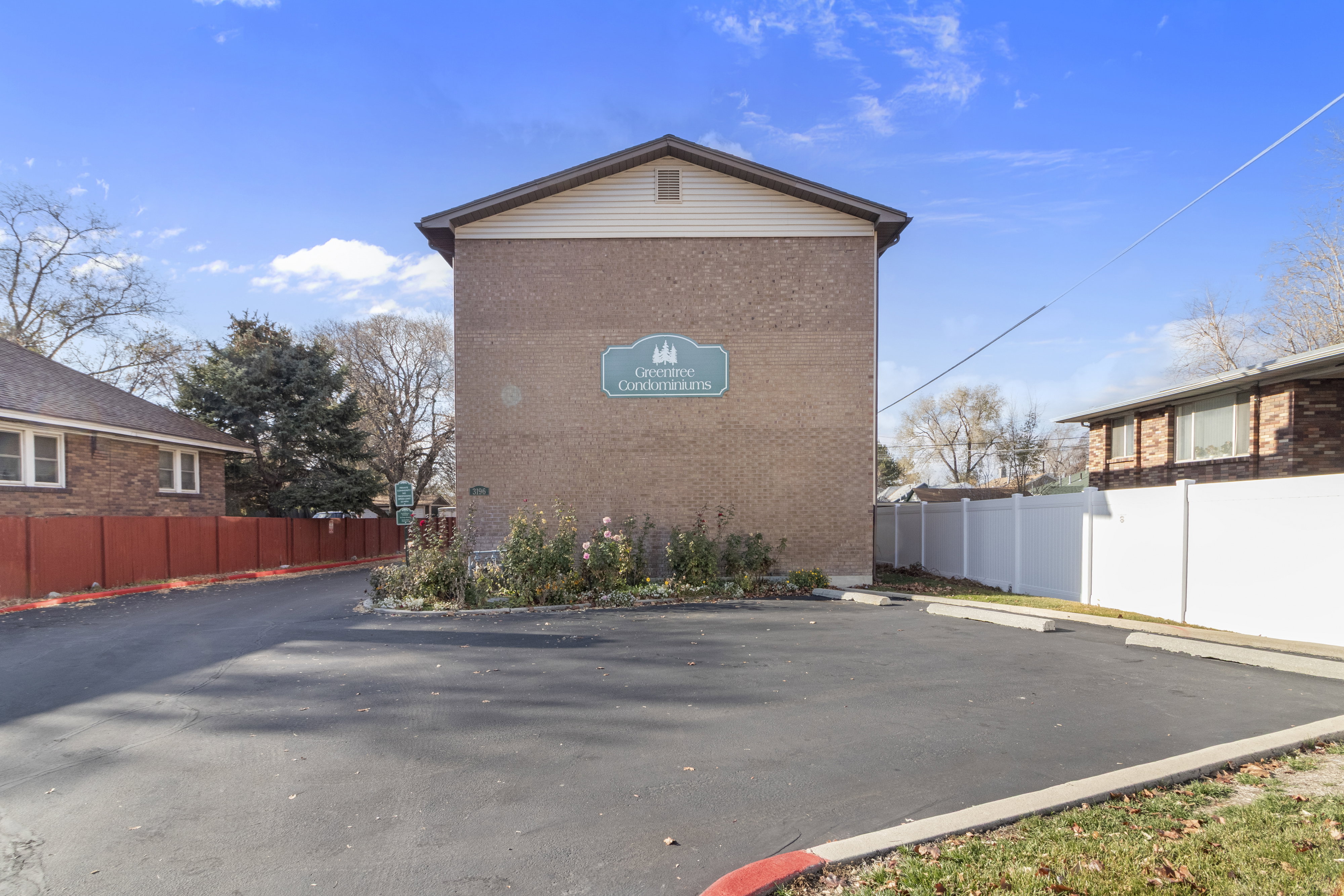 View of side of home featuring brick siding and uncovered parking