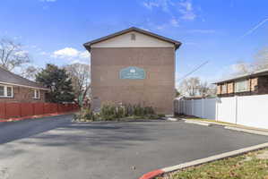 View of side of home featuring brick siding and uncovered parking
