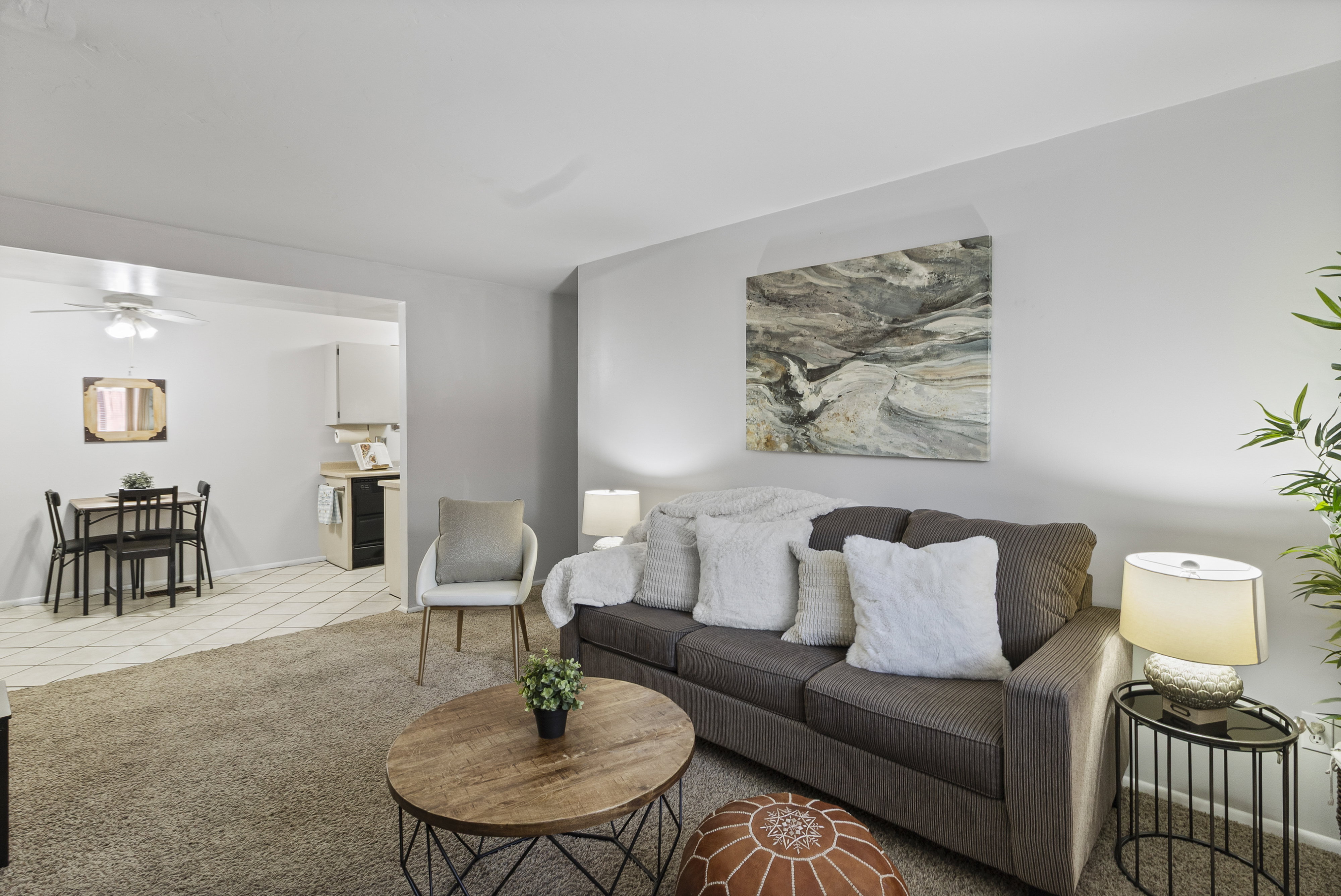 Living area featuring light colored carpet and a ceiling fan