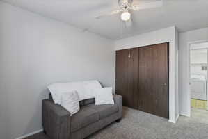 Sitting room featuring carpet flooring, washer / dryer, a textured ceiling, and a ceiling fan