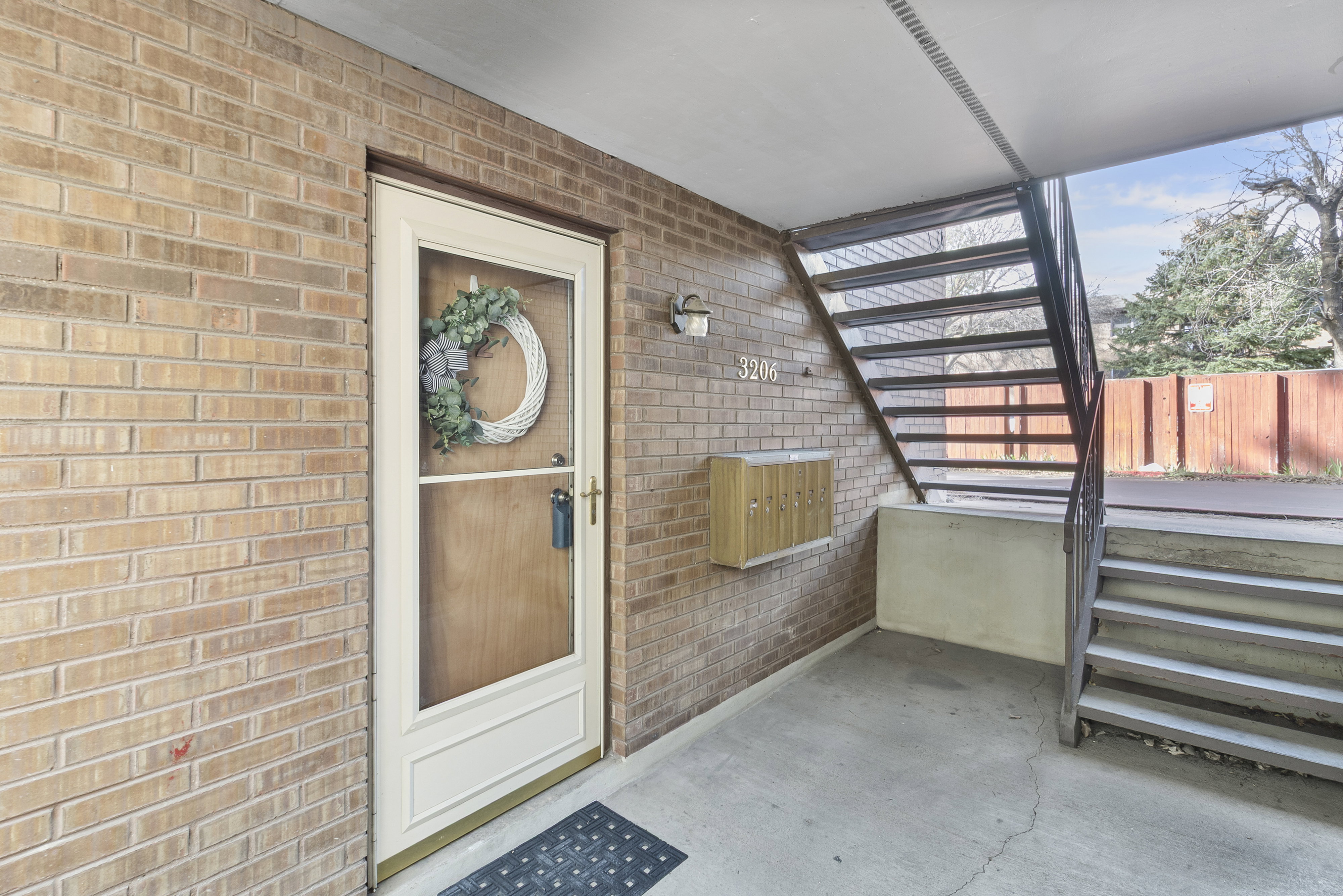Entrance to property with brick siding and a patio