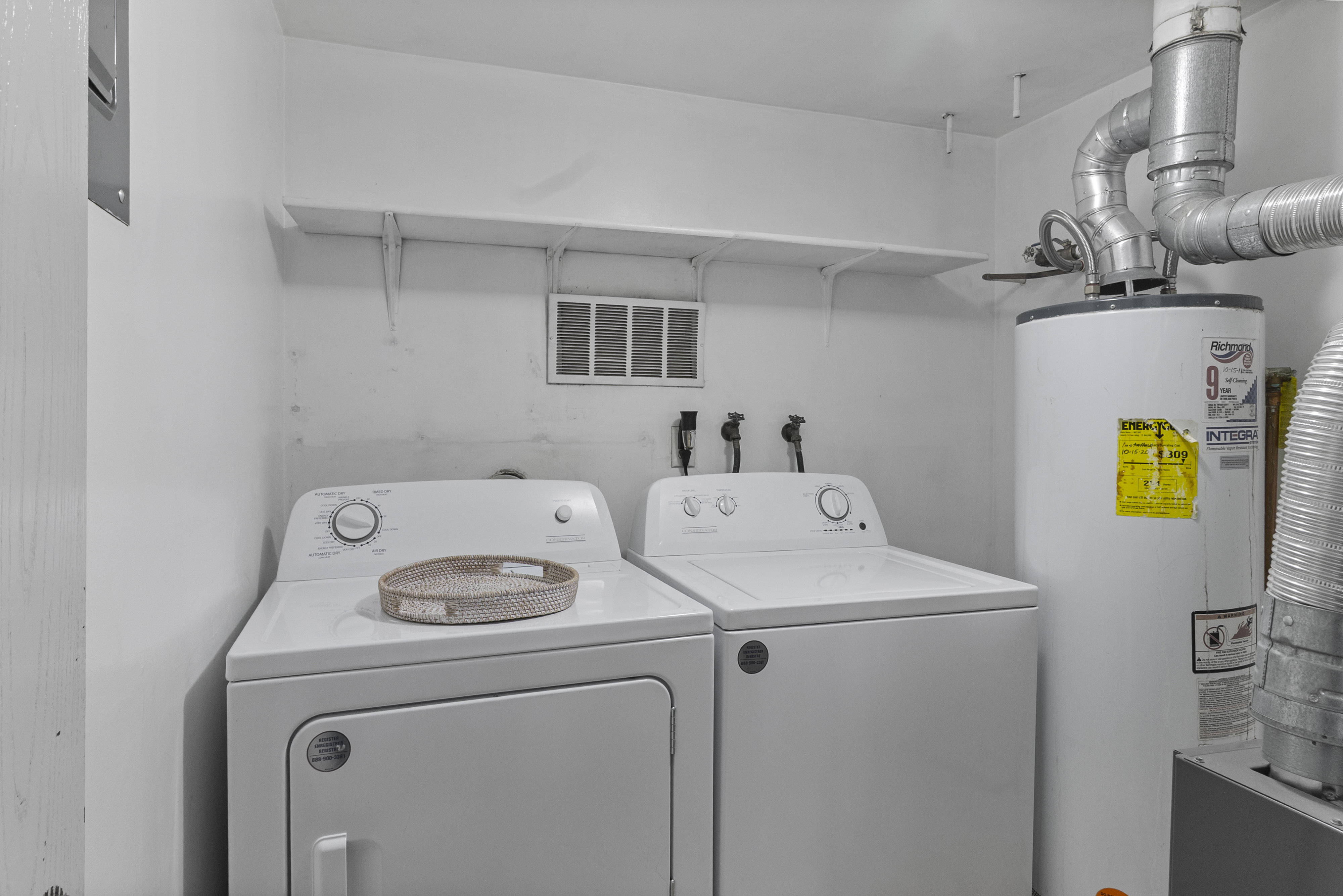 Laundry room with water heater and washing machine and dryer