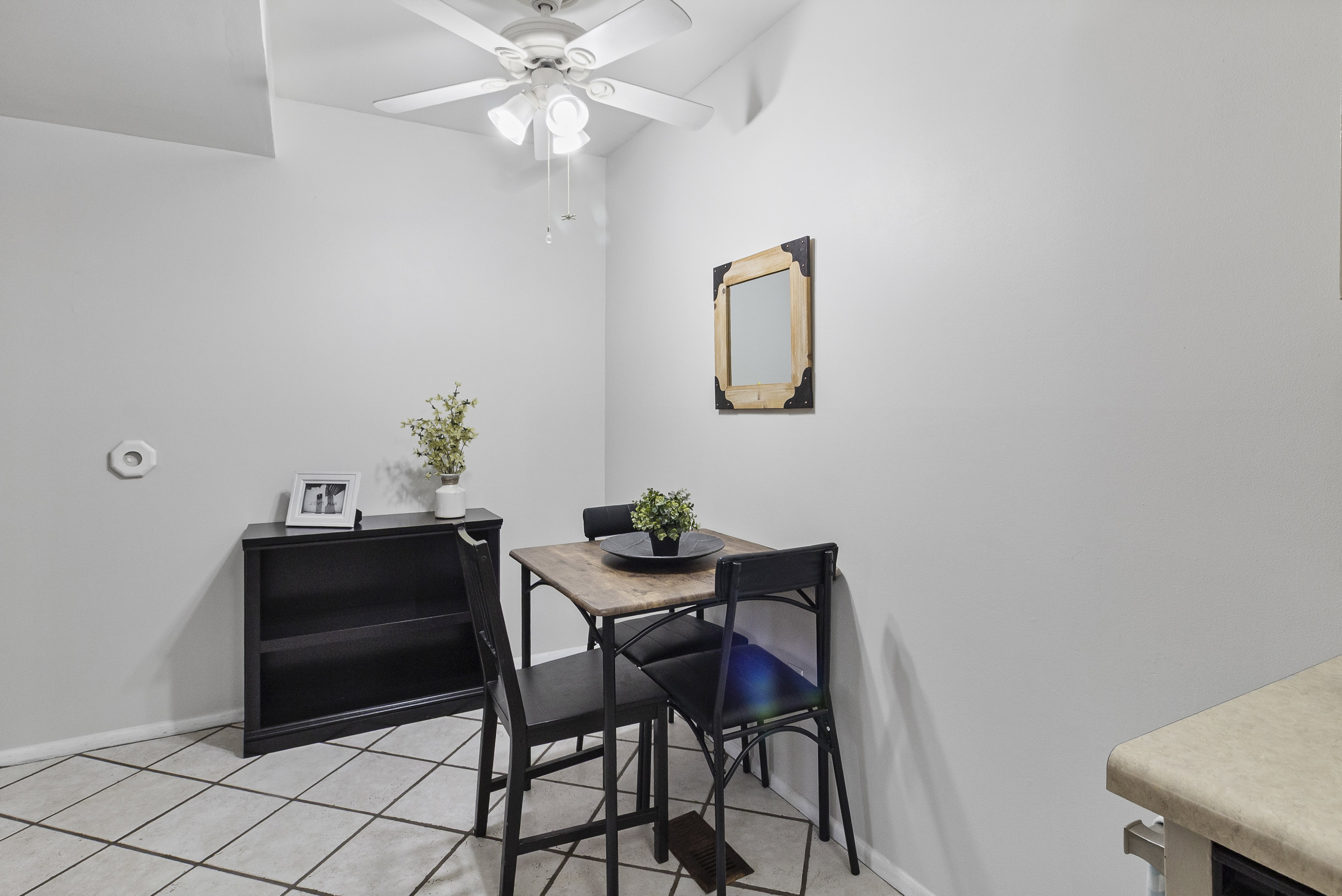 Dining room with light tile patterned flooring and ceiling fan