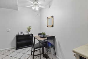 Dining room with light tile patterned flooring and ceiling fan