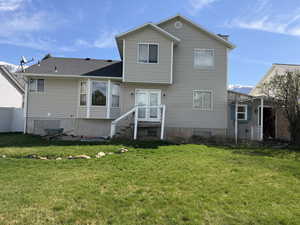 Rear view of house with a lawn
