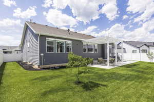 Rear view of property featuring a patio, a fenced backyard, and a pergola