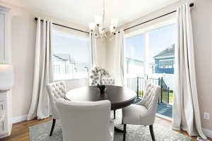 Dining space featuring light wood-style floors and suspended lighting