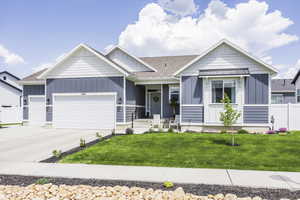 Ranch-style house featuring board and batten siding, a garage, concrete driveway, and a shingled roof