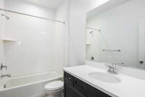 Bathroom featuring vanity and shower / bathtub combination