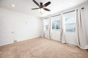 Spare room with ceiling fan, light colored carpet, and recessed lighting
