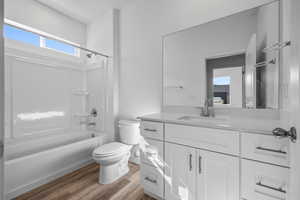Full bathroom with vanity, light wood-style flooring, and bathing tub / shower combination