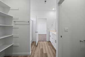 Full bath featuring vanity and light wood-type flooring