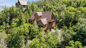 View from above of property featuring a tree filled landscape