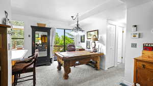 Office space with light colored carpet and baseboards