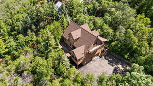 View from above of property featuring a tree filled landscape
