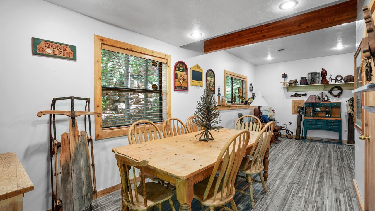 Dining room featuring wood finished floors, recessed lighting, and beamed ceiling