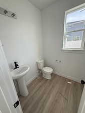 Half bathroom with wood finished floors