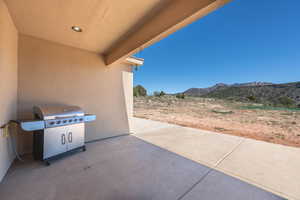 View of patio with grilling area and a mountain view