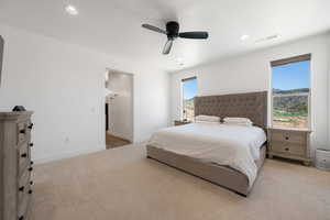 Bedroom featuring light carpet, ceiling fan, recessed lighting, and a mountain view