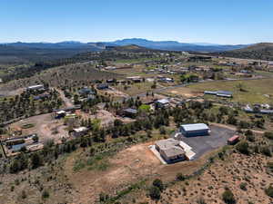 Aerial view of property's location featuring a mountainous background and rural landscape