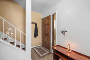 Entrance foyer featuring light wood-style flooring and a textured ceiling