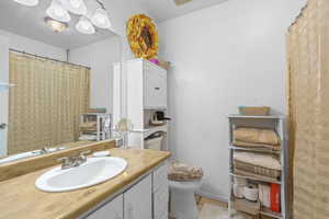 Bathroom featuring vanity, a shower with curtain, and light tile patterned floors