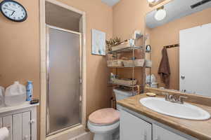 Bathroom featuring vanity and a stall shower