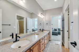 Jack and Jill bathroom with double vanity and  tile flooring