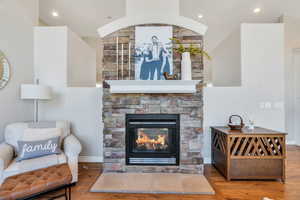 Great room with two-way  fireplace, hardwood finished floors, and recessed lighting