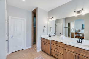 Master bathroom with double vanity, and a walk in shower