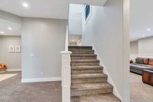 Stairway featuring recessed lighting and carpet floors